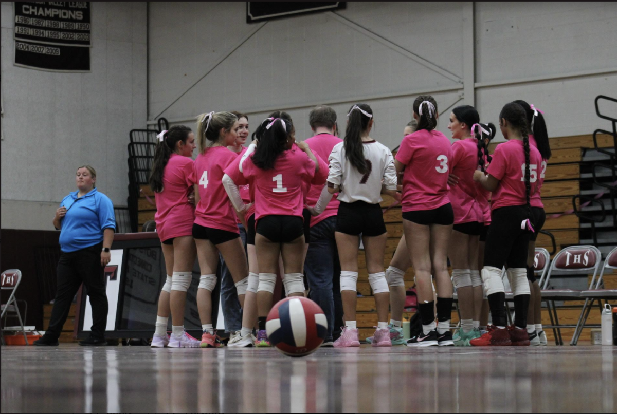 Girls Volleyball in their pink out jerseys supporting breast cancer!